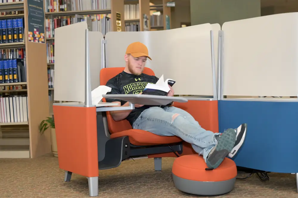 student in a wheelchair in a library