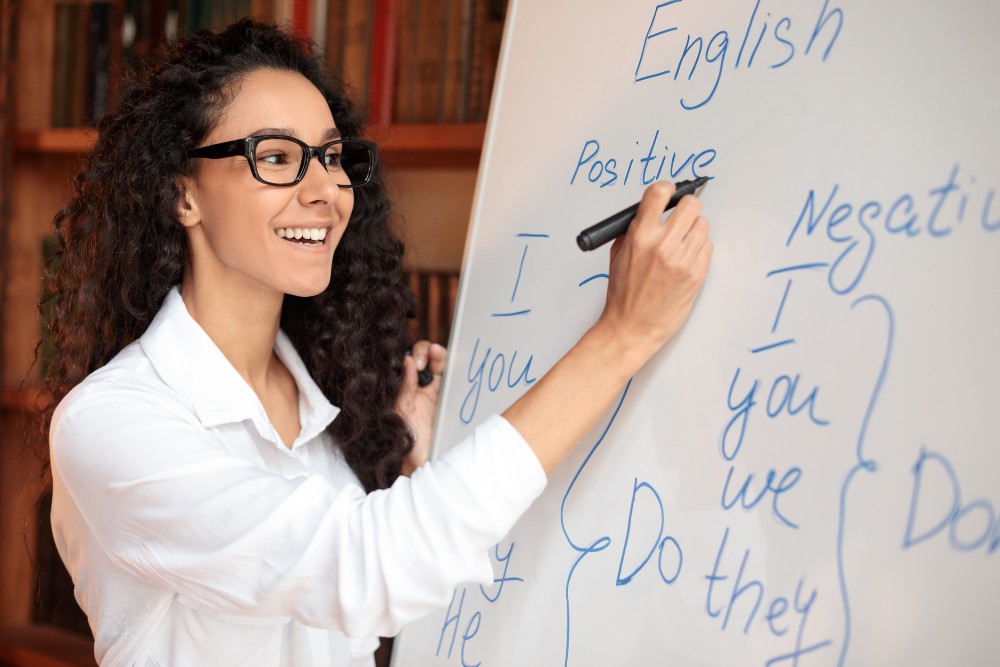 female teacher writing on board