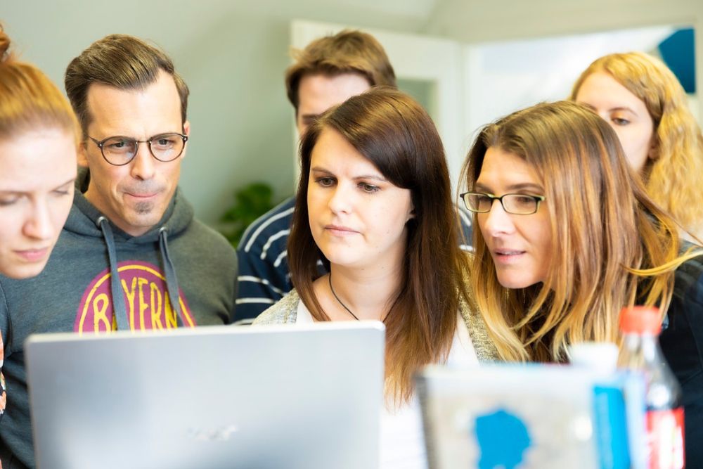 students gathered around a computer